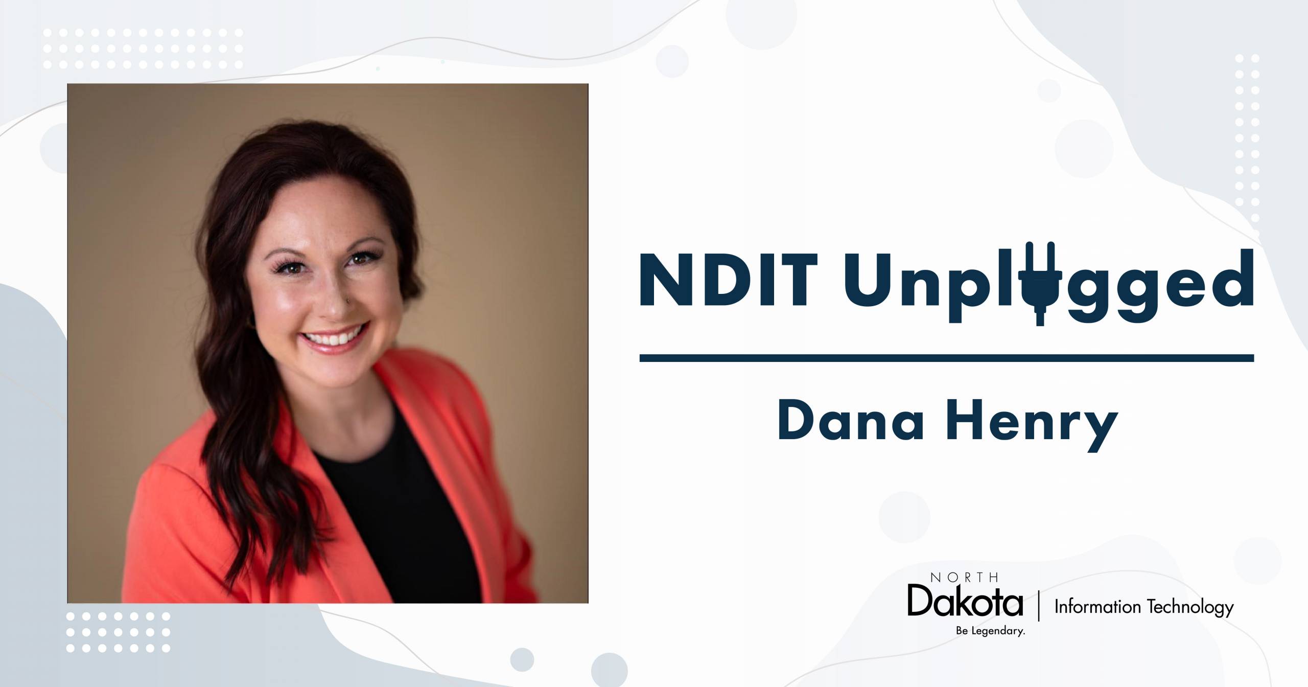 A middle-aged Caucasian woman with long black hair, dressed in a black shirt and red blazer. To her right is the NDIT Unplugged blue logo, featuring the 'U' in 'Unplugged' creatively designed as a power plug.